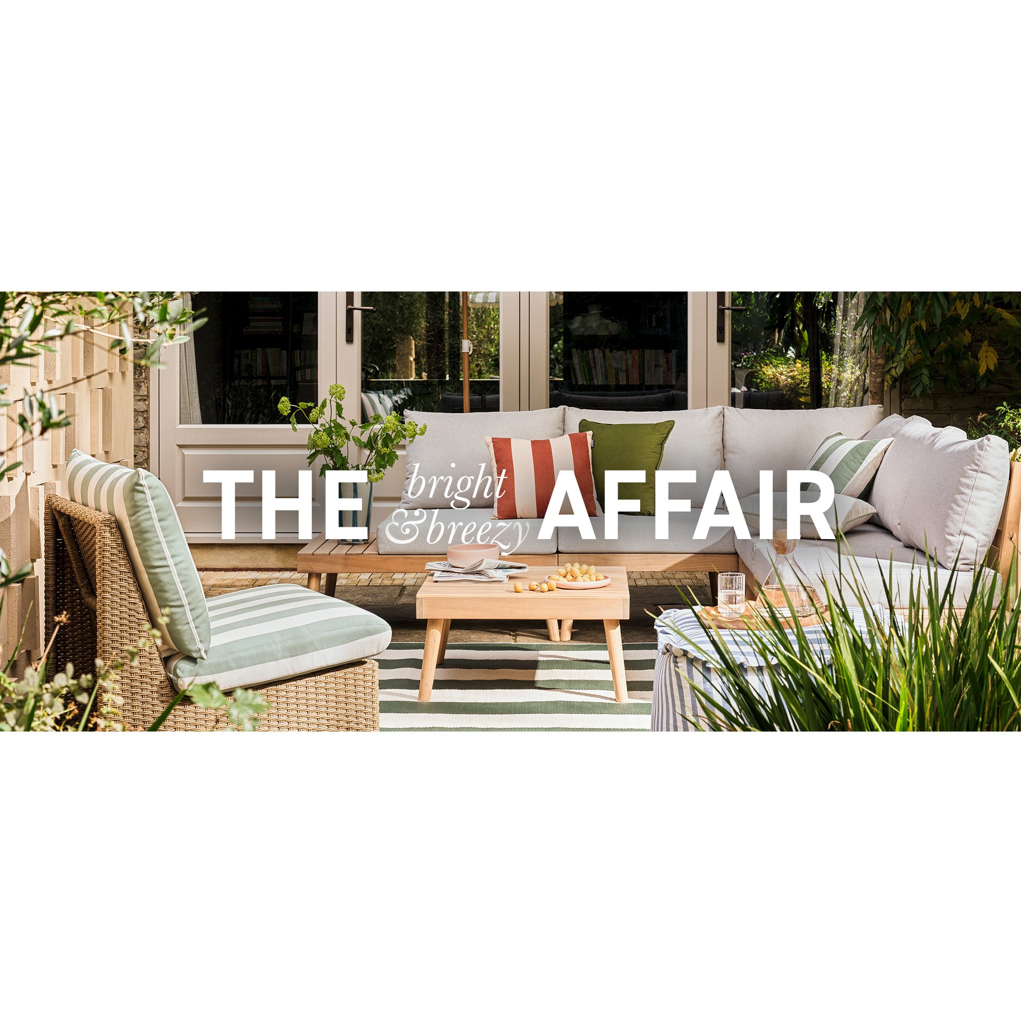 A beautiful garden decorated with garden furniture, plants, and ornaments.