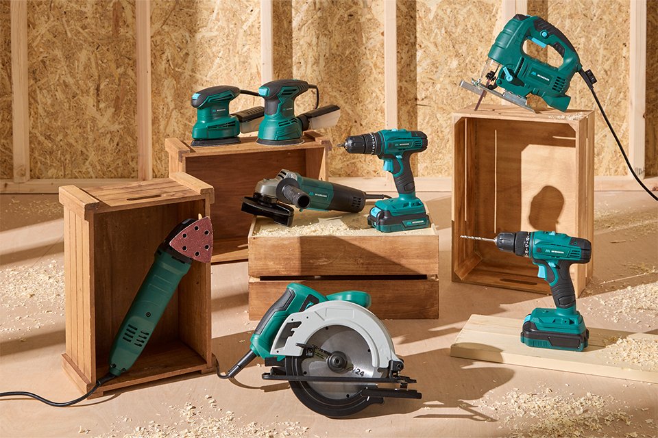 An assortment of McGregor's new range of DIY power tools displayed against a wooden background.