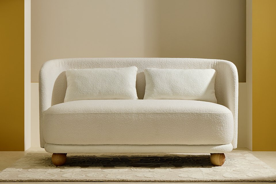 Habitat Poppy Fabric 2 Seater Sofa in natural finish placed in a living room on a rug.