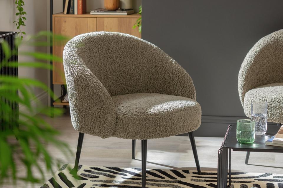 Ash boucle chair sitting in a living room.