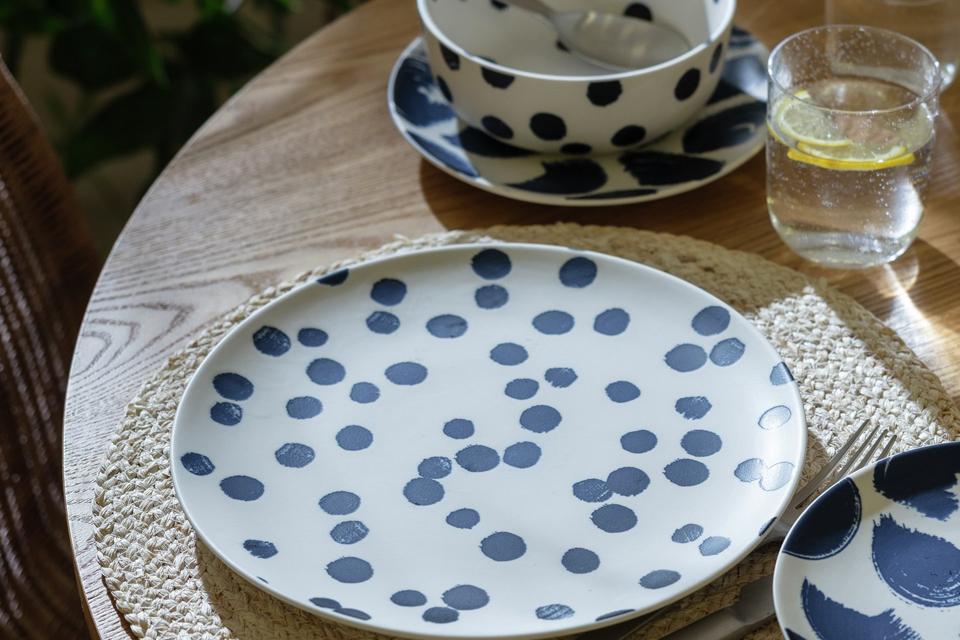Spotty dinner set sitting on a dining table.