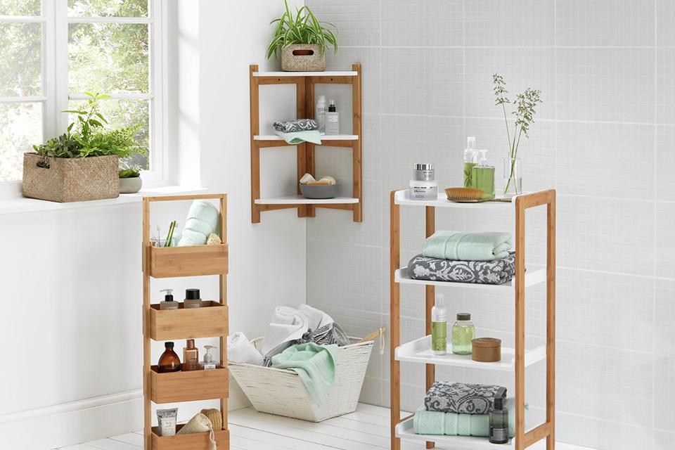Bathroom storage including a bamboo  caddy and shelves.