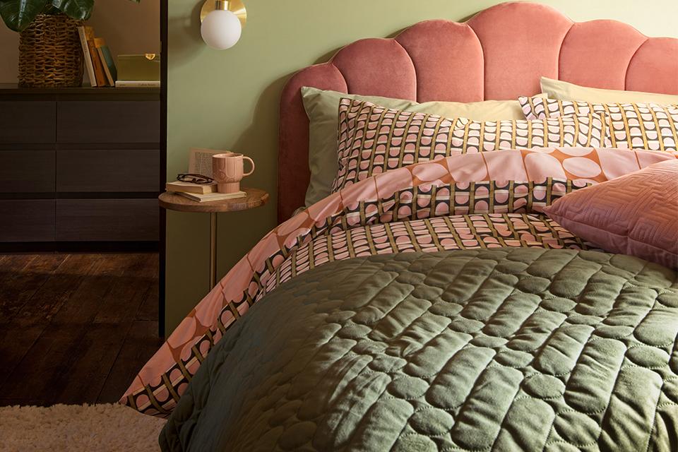 : A gorgeous bedroom with light pink and soft green interiors.