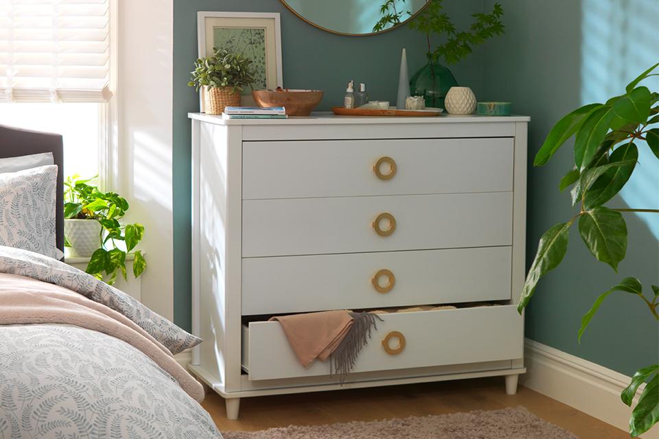 A white four-drawer bedroom storage unit.