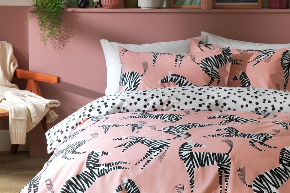 A bedroom with zebra-printed bedlinen on a double bed.