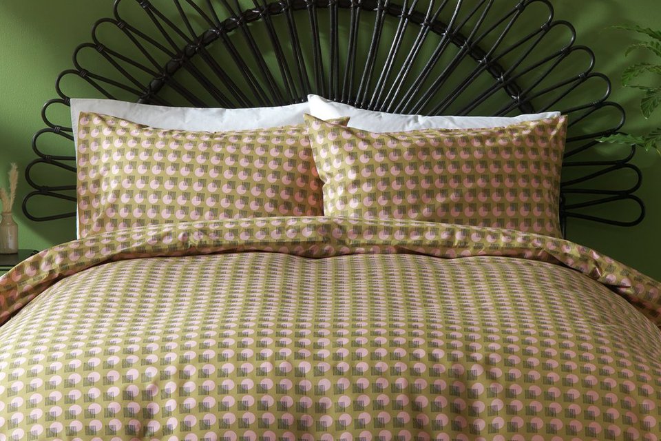 Patterned bedding on bed with wire bed frame.