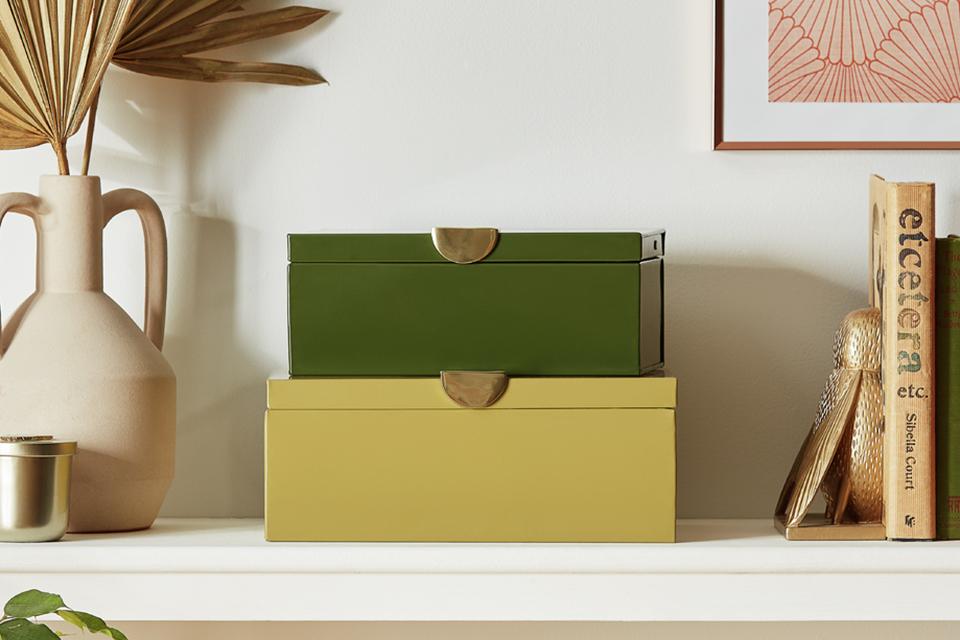 Two green and yellow Habitat Citrene storage boxes on a shelf.