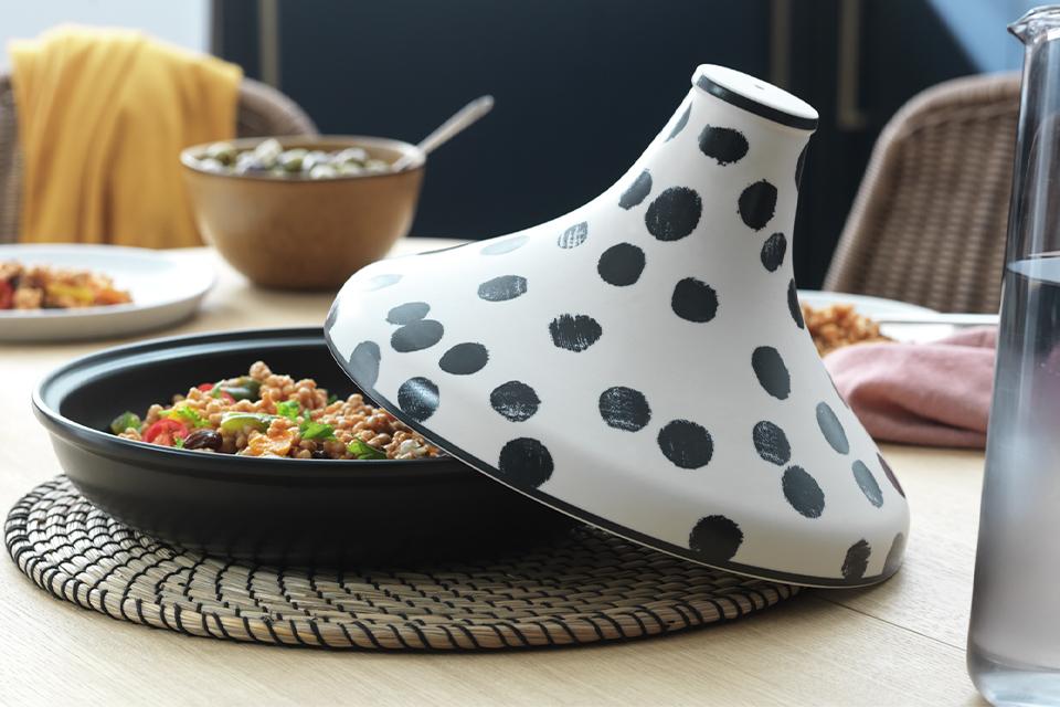 A close up image of a tagine cooking pot with polka dot print in black and white colour.