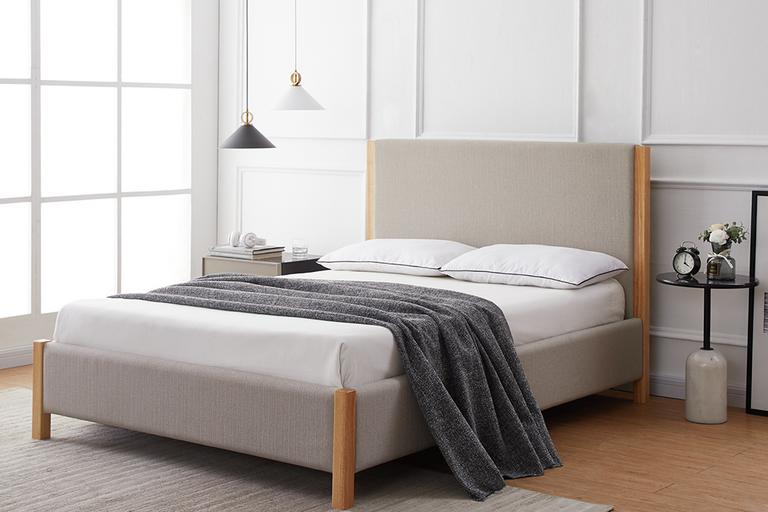Light grey fabric bed.