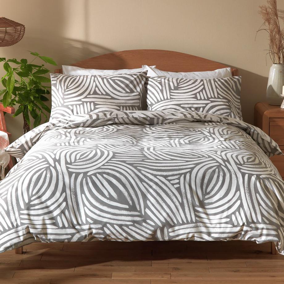 A Scandi-style bed with striped bed linen on a double bed.