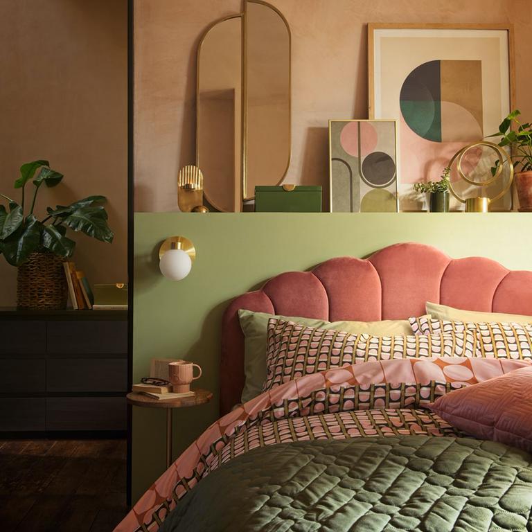 A bedroom in soothing pastel shades of pink and green.