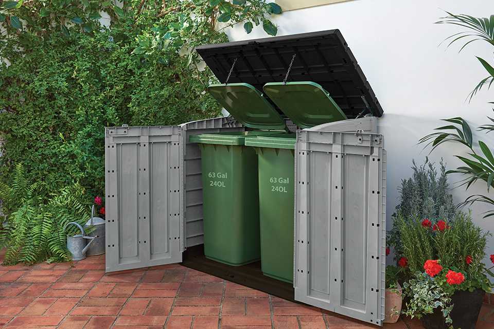 Keter Store It Out Max outdoor storage box with piston assisted lid and 2 wide opening doors hiding 2 big wheelie bins.