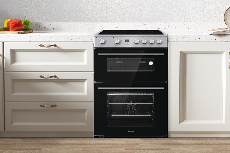 A Hisense HDE3211BXUK 60cm Double Oven Electric Cooker in a kitchen.