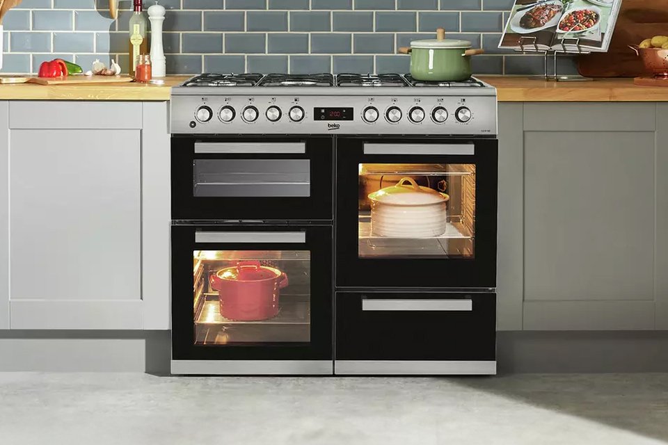 Three pots on and in a Beko KDVF100X 100cm Dual Fuel Range Cooker - Stainless Steel.