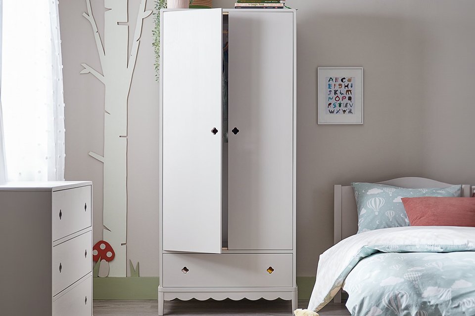 Kids white bedroom wardrobe in room.
