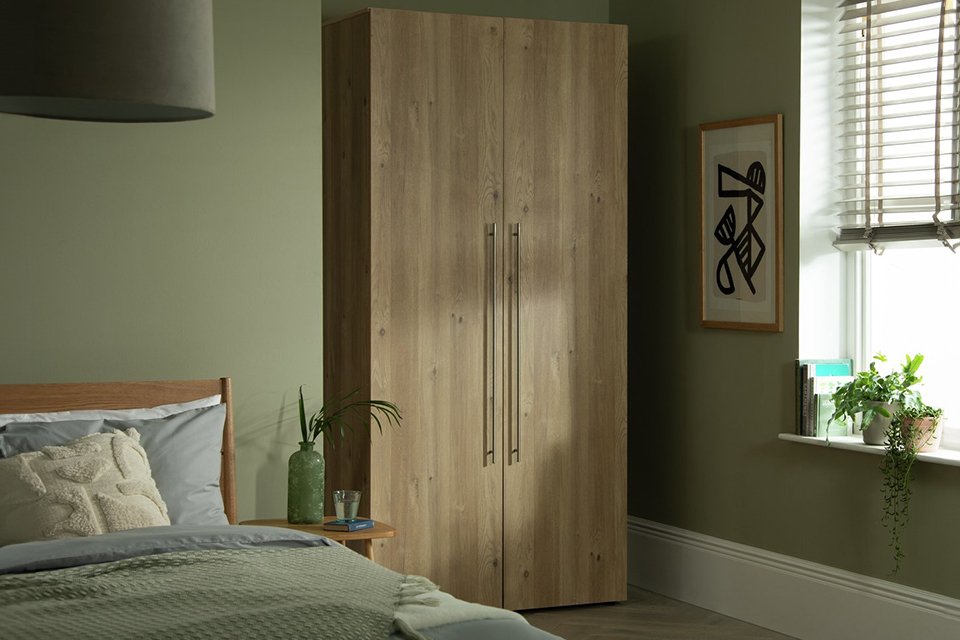 Wooden wardrobe in green bedroom.