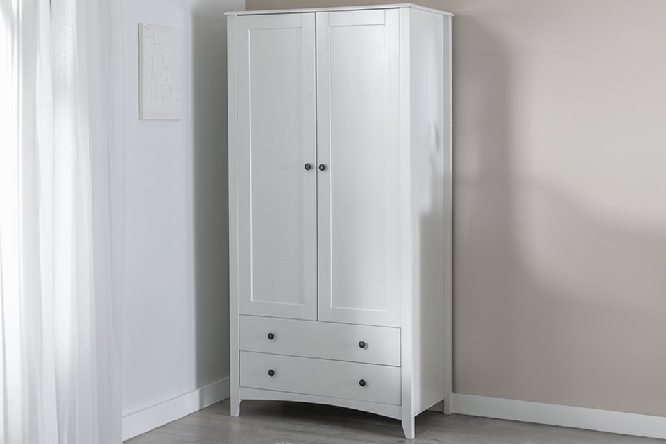 White minimal wardrobe in bedroom.