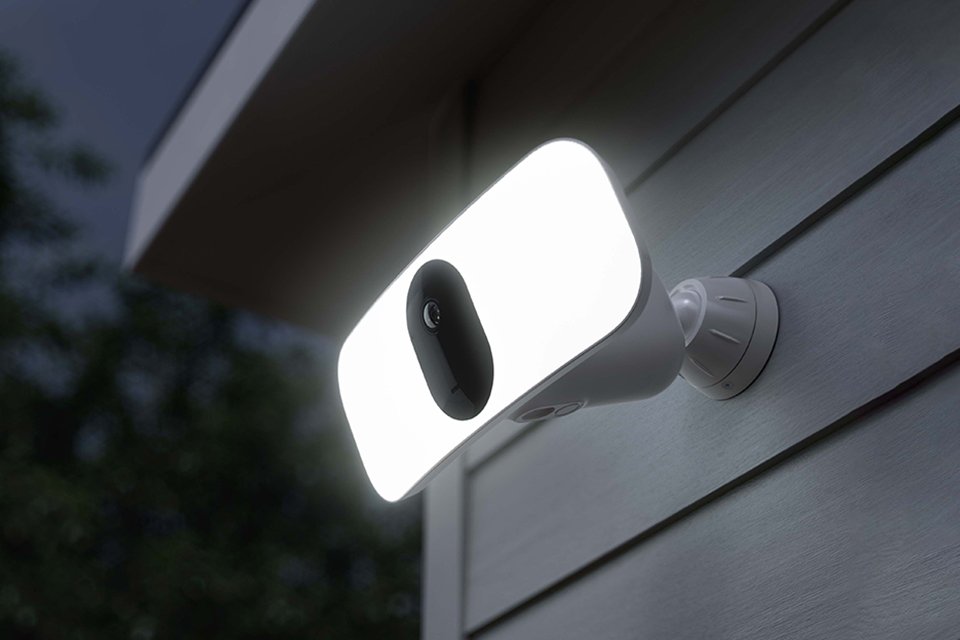 A white Arlo Pro 3 floodlight outdoor security camera. 