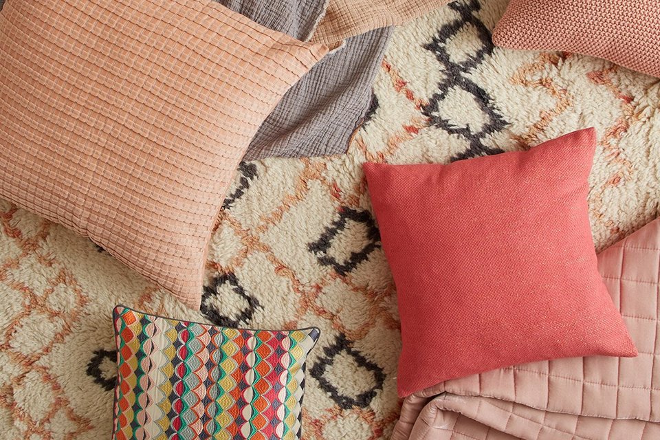 Berber style rug with cushions on top.