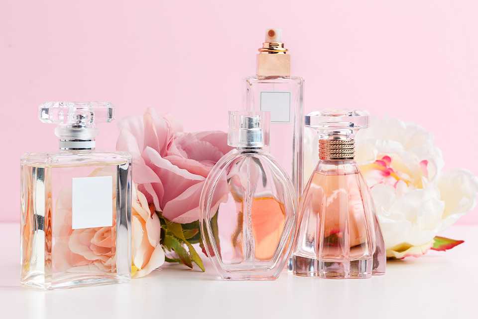 A collection of perfumes and flowers.
