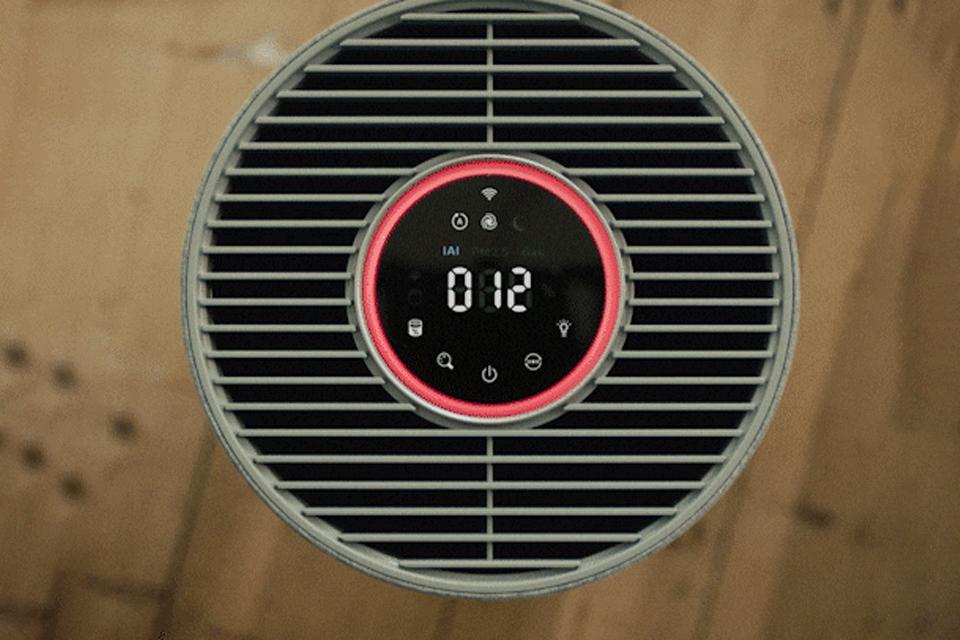 A close-up of a Philips air purifer's circular digital display, with a red glowing ring of light around the edge and numbers at the centre. 