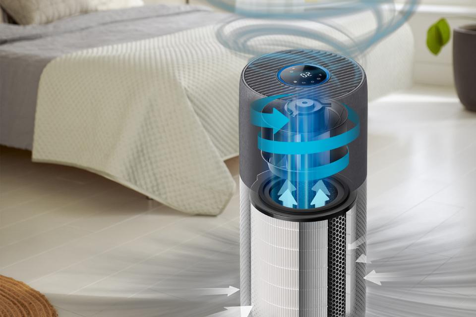 A Philips air purifier in use, with arrows to show the flow of air going in and blue waves to show the flow of clean air out from the purifier and around the room.