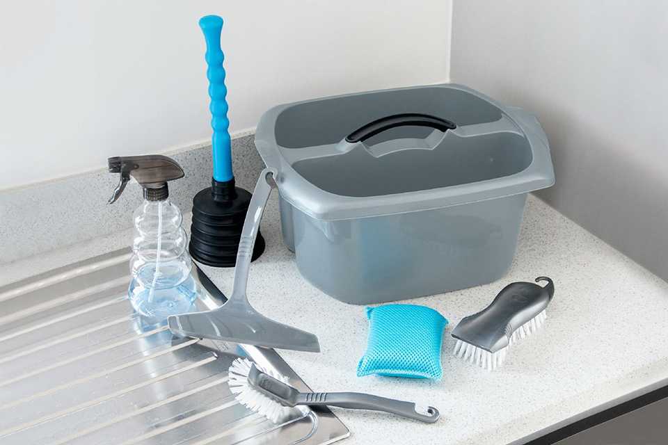 Addis cleaning caddy set with scrub brush, squeegee, spray bottle, dish brush, sponge and plunger.