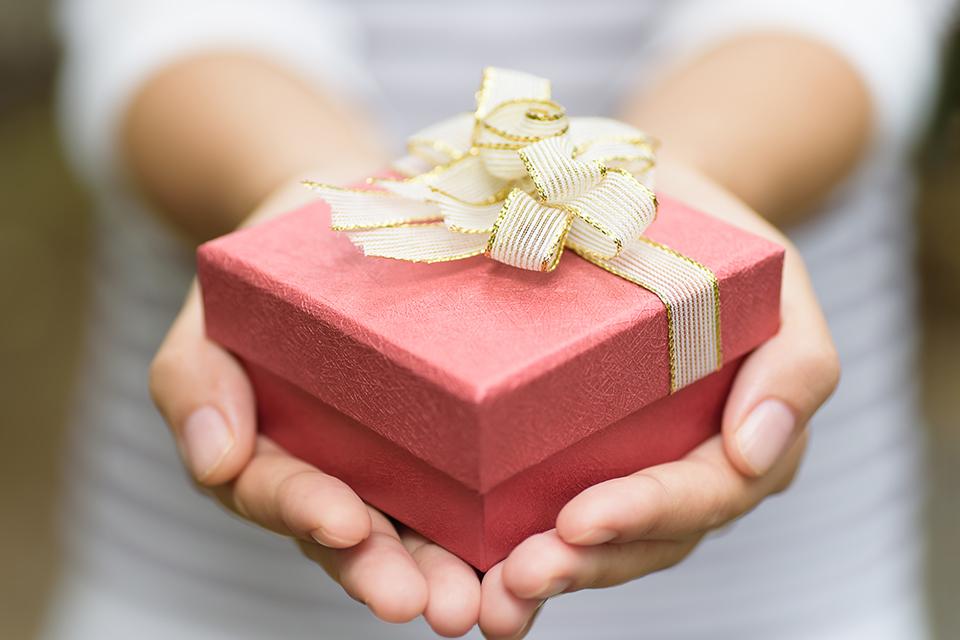 A small present cupped in hands.