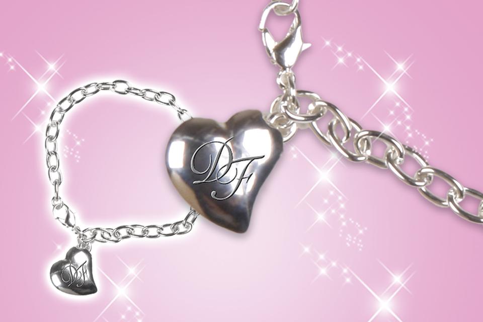 A DesignaFriend charm bracelet with a letter-engraved heart pendant.