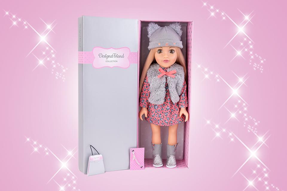 A DesignaFriend doll with a branded boutique style gift box.