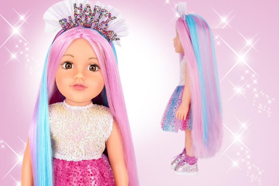 A DesignaFriend doll with colourful hair wearing a sparkly birthday crown.