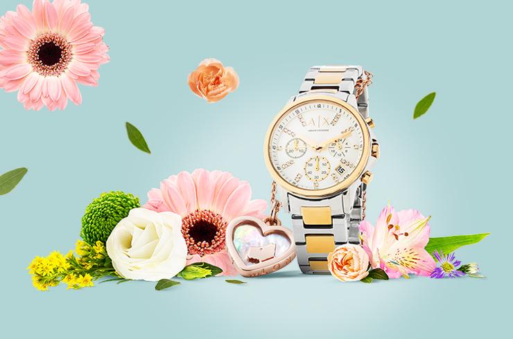 A watch and a pendant on a flower background.