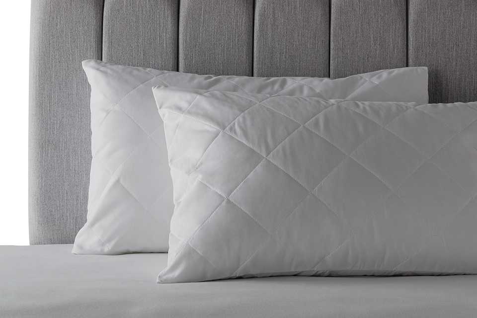 Habitat anti-allergy pillows sitting on a bed.