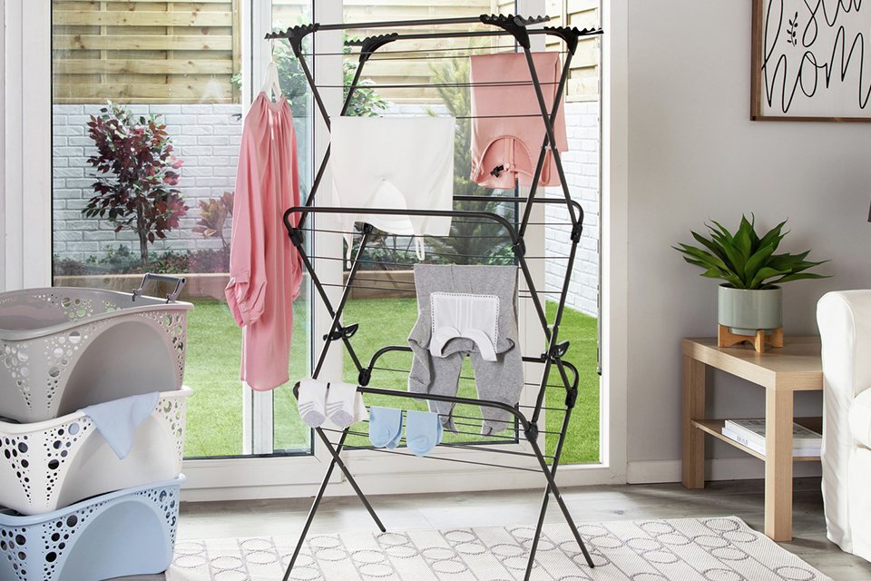 Clothes drying on a clothes airer in the house.