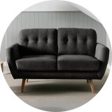 A Habitat Finney fabric 2 seater sofa in charcoal in a living room.