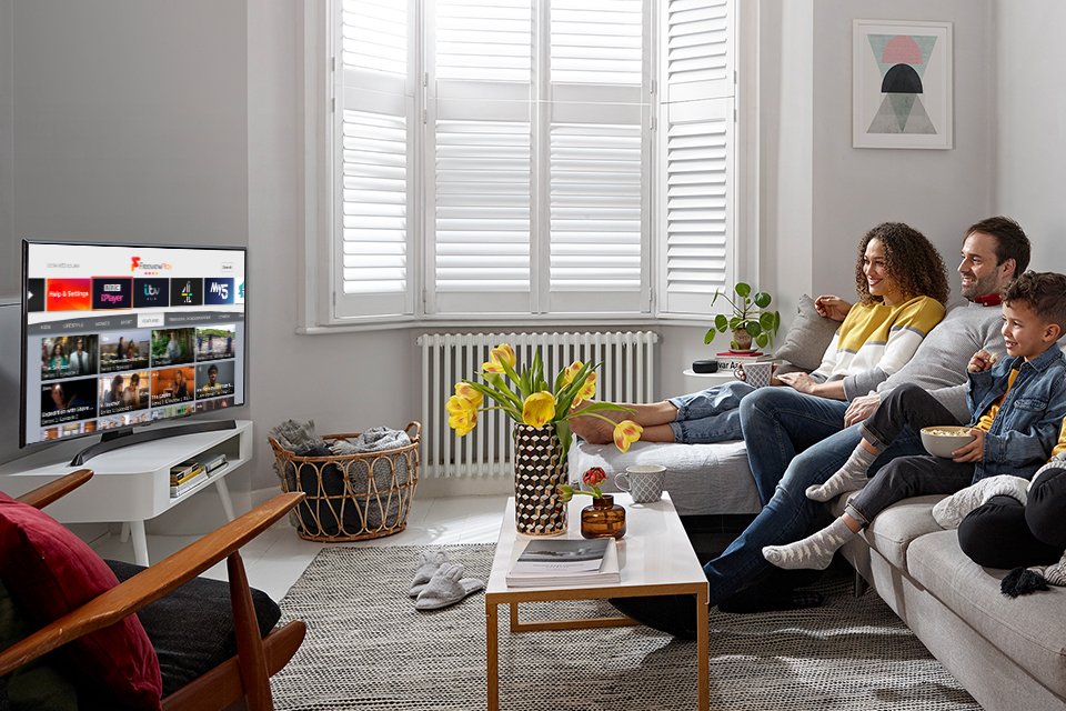 A family exploring their favourite series and shows on their Freeview Play television.