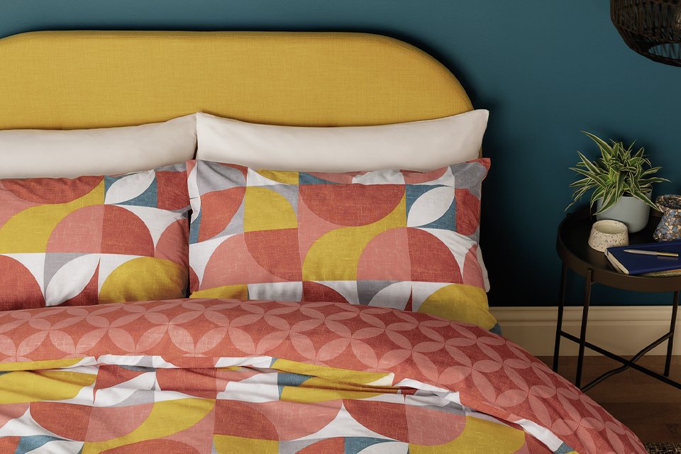 Burnt orange and yellow geometric reversible bedding.
