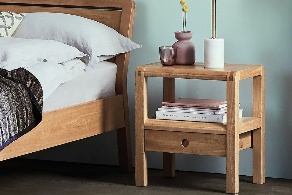 Oak two drawer bedside table with bedside light.