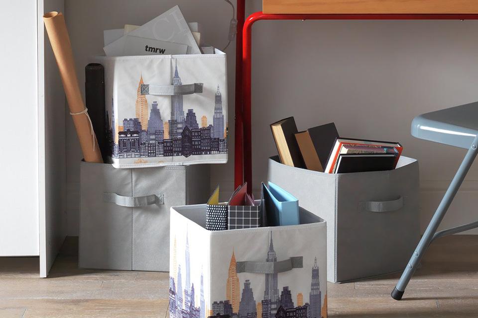 The Argos Home Teen City canvas box in a teen bedroom setting, filled with folders. 