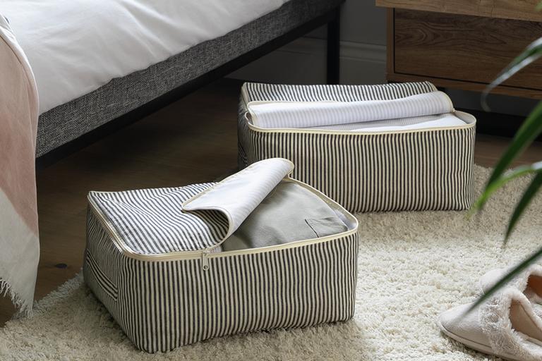 A set of 3 underbed storage bags in natural finish. 