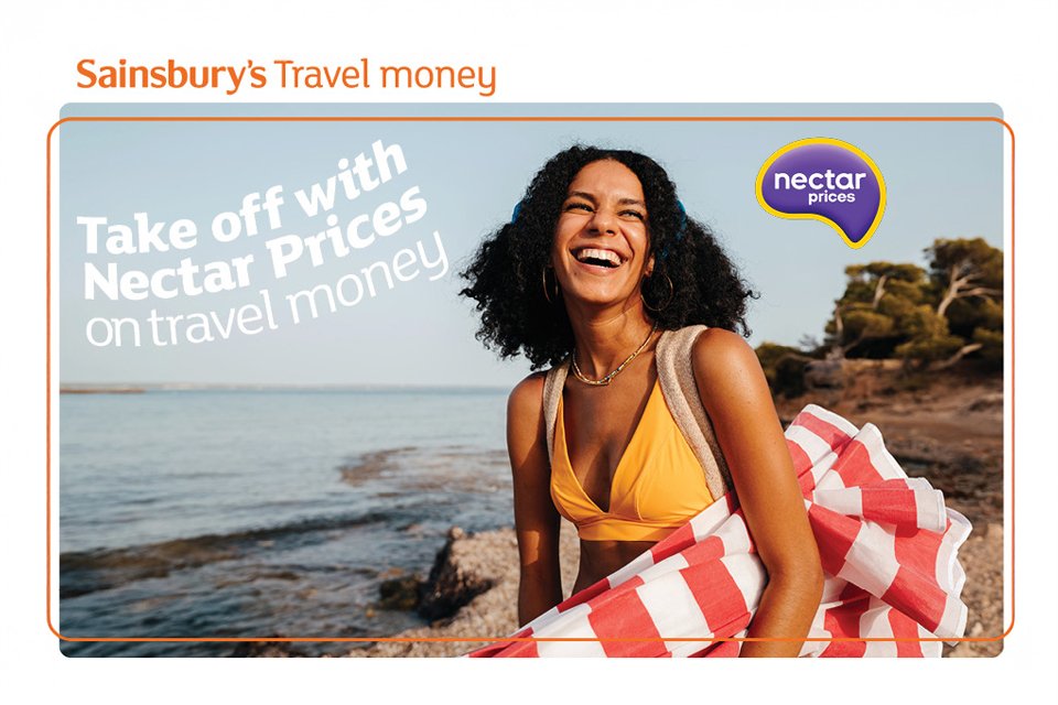 Sainsbury's travel money poster showing a happy woman in her swim suit at a beach.