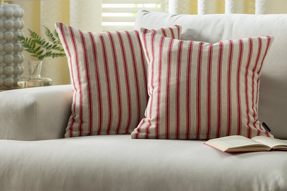 Two red striped Habitat cushion covers 43x43cm on a white sofa.