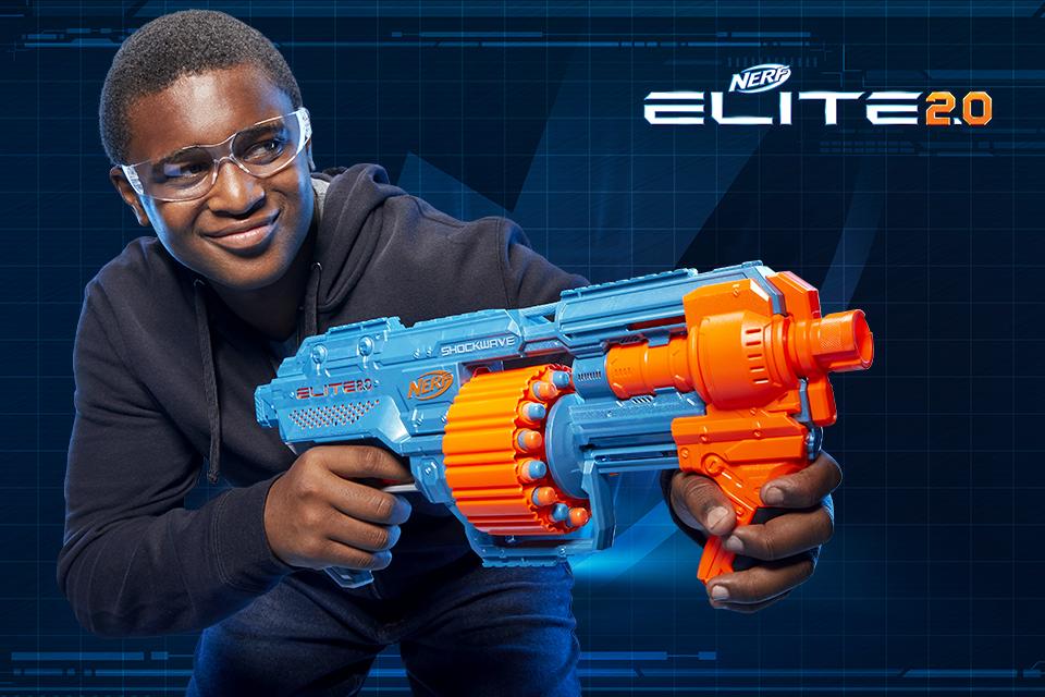 A boy in a black jumper holding a Nerf Elite 2.0 blaster.
