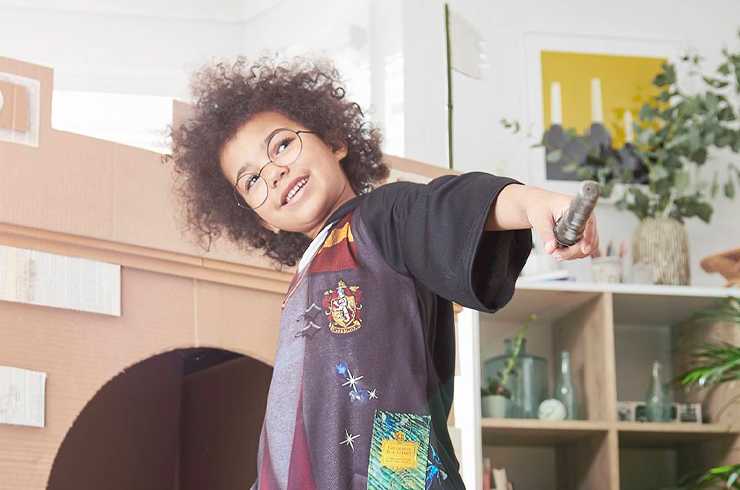 A boy wearing Harry Potter Gryffindor costume.