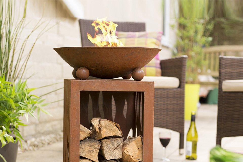 La Hacienda Aged Effect Fire Bowl in high quality steel with a practical compartment underneath for fire logs.