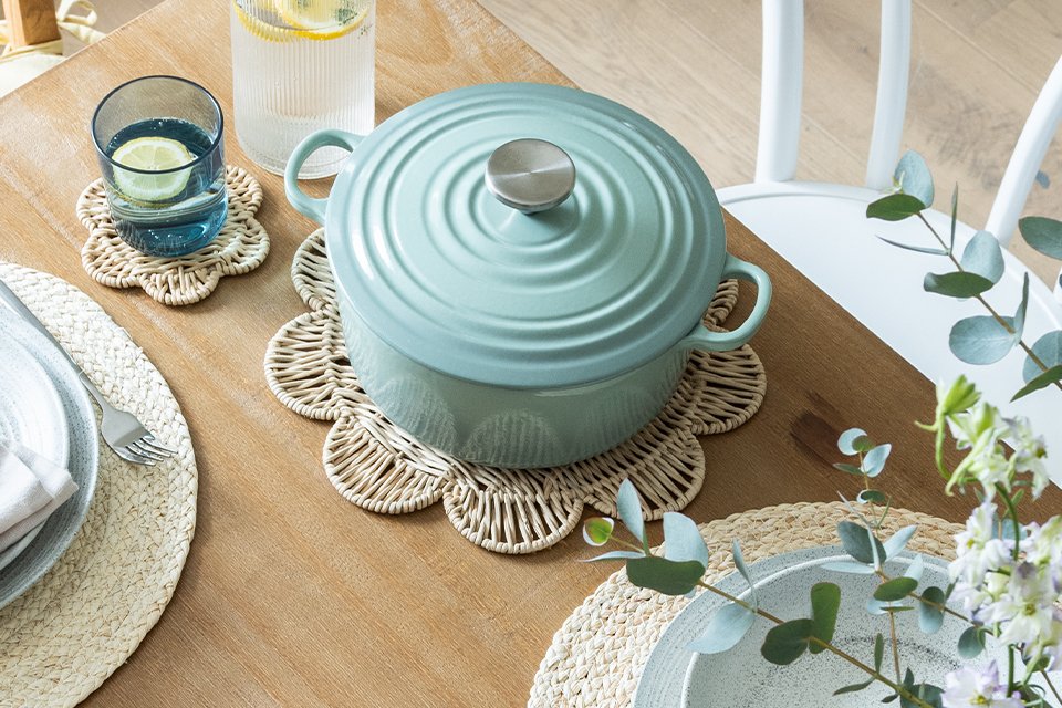 A light blue coloured cookware kept on a table.