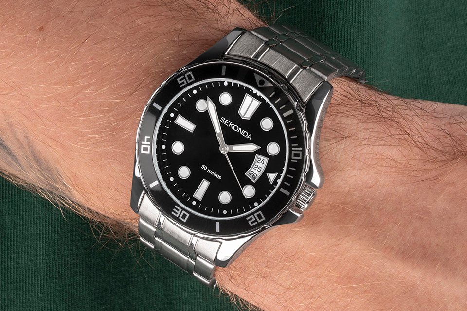 A man wearing a Sekonda men's stainless-steel bracelet watch with black dial.