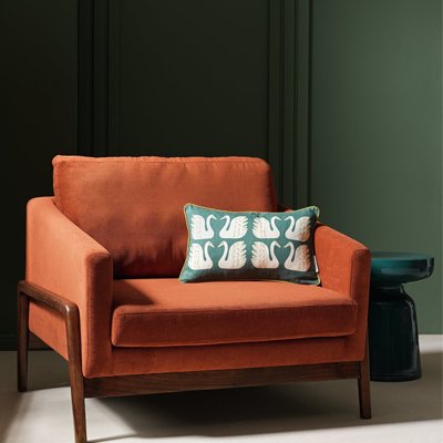 Esla brown armchairwith blue swan cusion.