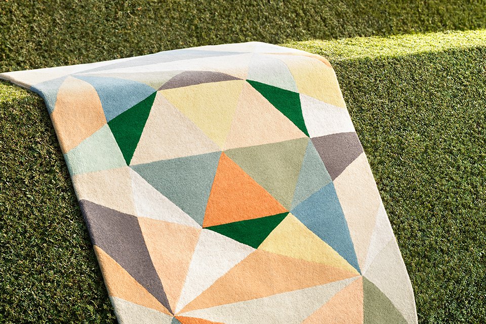 A colourful Habitat patterned rug placed outdoors in the sun.