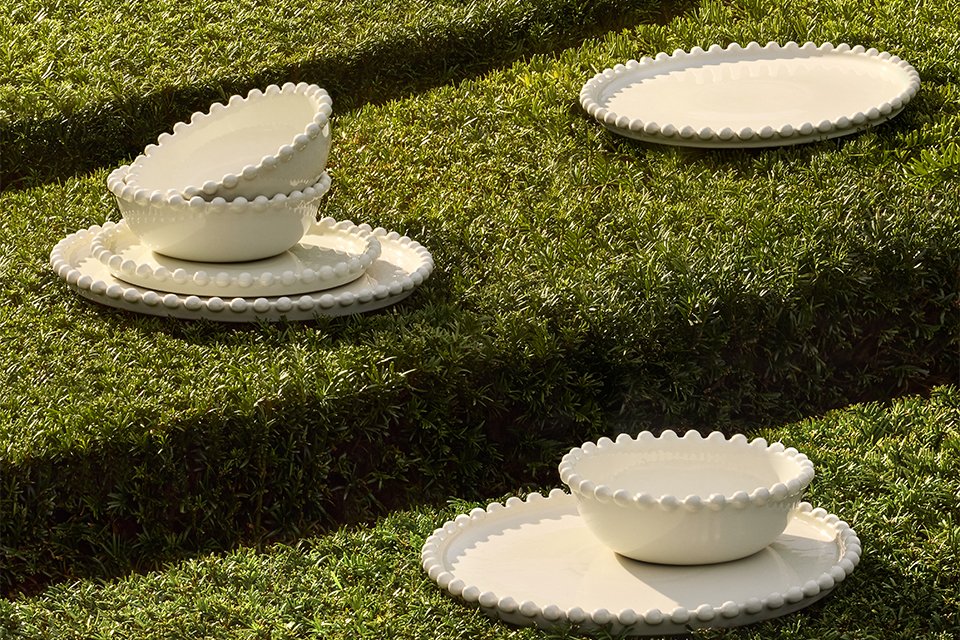 A white Habitat dinner set placed outdoors in the sun.